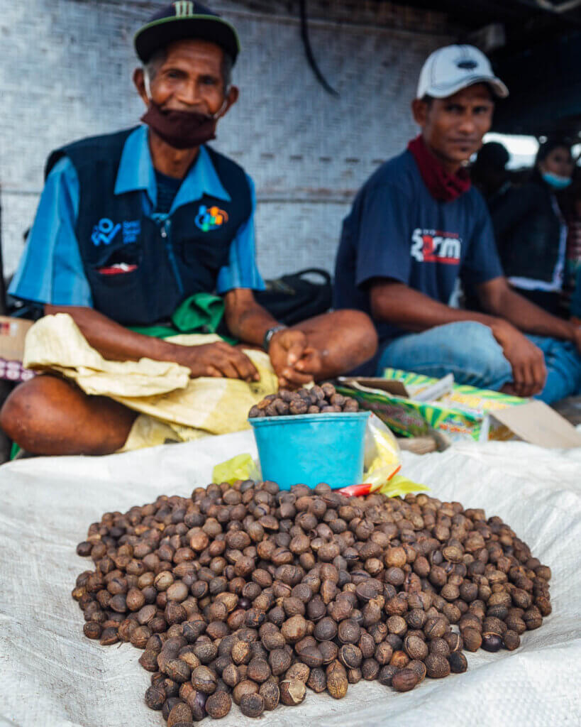 Indonesian men with their goods at the local Market Melolo