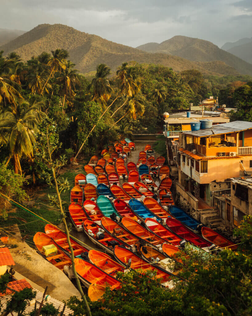 Scenic Charm: Exploring Choroni's Riverside with Colorful Boats on My Venezuela Travel Itinerary