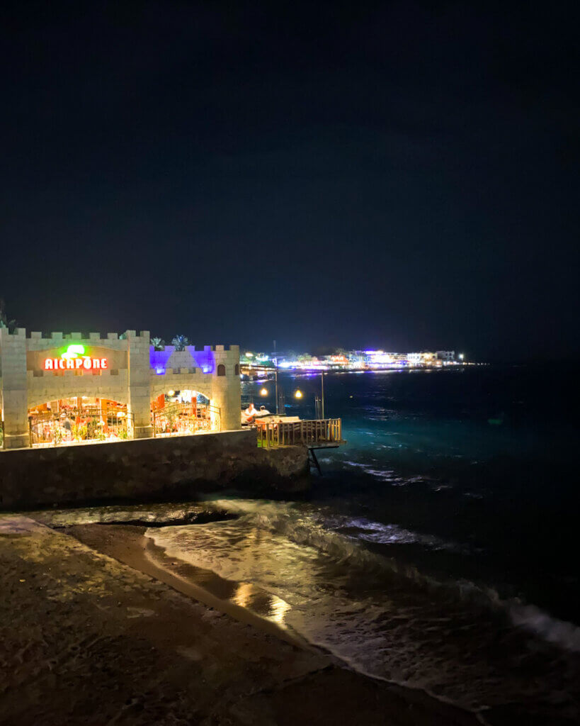 Stunning waterfront view at night with illuminated restaurants in Dahab.