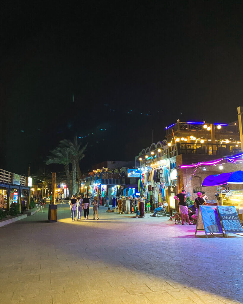  Taking a leisurely stroll along the vibrant streets of Dahab at night.