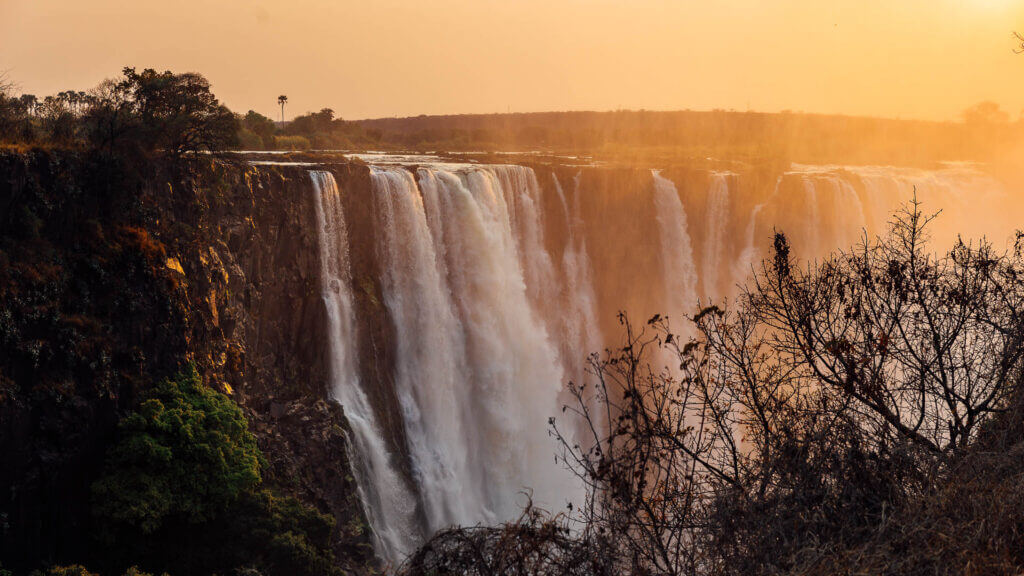  A wide panoramic view of Victoria Falls, showing the powerful cascade of water