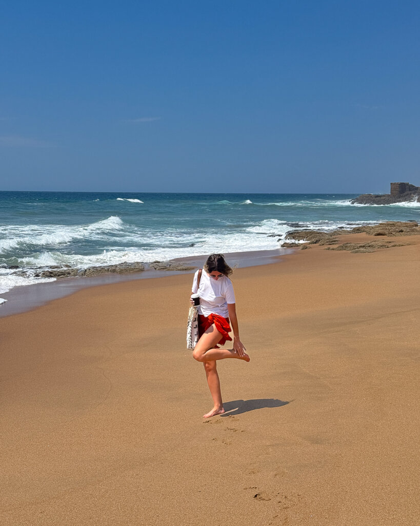 Woman walking along Ballito beach