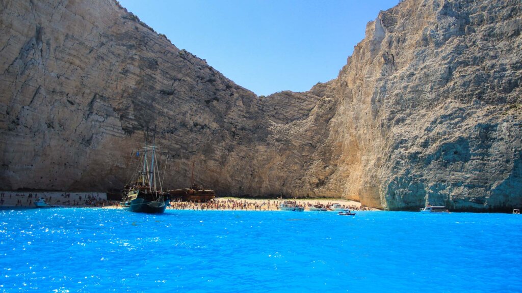 Navagio Shipwreck Beach Zakynthos rusted vessel white pebble limestone cliffs