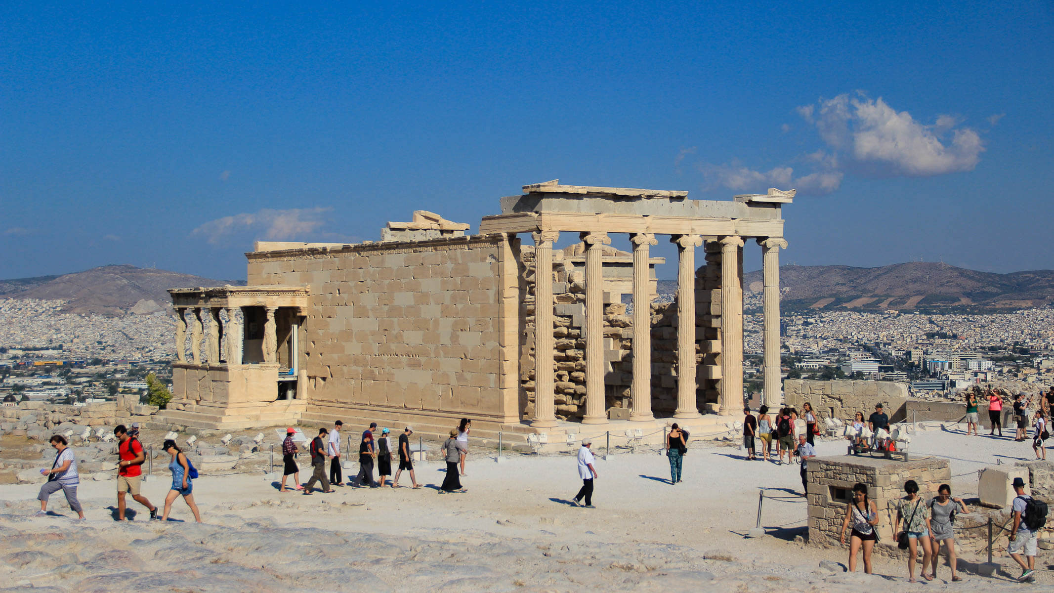 The Acropolis lit by warm sunset light above the Athens skyline